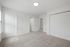 Bright, modern bedroom with plush carpet, ample natural light, and sleek double closet doors.