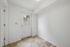 Bright entryway showcasing elegant tiled flooring and pristine white walls for a welcoming atmosphere.