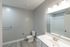 Modern bathroom featuring sleek vanity, polished fixtures, and elegant flooring, designed for contemporary living.