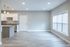 Bright and modern open-concept apartment with sleek kitchen, granite countertops, and spacious living area with large windows.