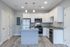 Modern kitchen with sleek white cabinetry, stainless steel appliances, and elegant granite countertops.