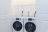 Modern laundry closet showcasing high-efficiency front-loading washer and dryer, perfectly integrated into the apartment layout.