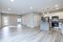 Modern open-plan apartment with sleek hardwood flooring, bright kitchen featuring stainless steel appliances, and ample natural light.