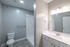 Modern bathroom with sleek fixtures, spacious shower, and elegant vanity in a bright, minimalist design.