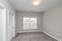 Bright, spacious room with elegant carpeting and a large window inviting natural light.