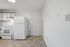 Bright and modern kitchen area featuring sleek appliances and stylish tiling, perfect for culinary adventures.