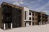 Modern apartment building with stylish balconies against a clear blue sky, enhancing urban living appeal.