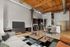 Stylish open-concept living space features high wooden ceilings, modern kitchen, and elegant dining area with cozy seating for relaxation.