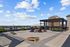 Expansive rooftop terrace with chic pergola, modern seating, and stunning city views, perfect for relaxation and entertainment.