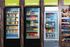 Vibrant convenience store coolers displaying fresh food, diverse drinks, and frozen selections with colorful packaging.