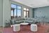 Bright and modern living area featuring a stylish green sectional, chic marble coffee table, and elegant patio view, perfect for relaxation and entertainment.