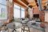 Chic industrial-style living room with exposed brick walls, large windows, and modern furnishings. Cozy seating area harmonizes with rustic details for a stylish urban vibe.