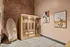 Inviting wellness room featuring a modern sauna, stylish abstract wall art, and unique contemporary mirror, set against a warm brick accent wall.