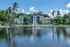Lakeside apartment complex with palm trees and fountain