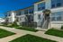 Stylish modern townhouse with landscaped front yard and private entrances.