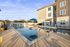 Inviting outdoor pool area with stylish lounge chairs, modern outdoor furniture, and a serene atmosphere.