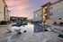 Discover luxury living with a stunning apartment pool area, featuring modern lounge chairs and vibrant sunset views.