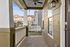 Charming porch with a cozy swing and ceiling fan