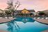 Resort-Style Pool and Clubhouse Exterior at Sunset