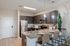 Modern kitchen with sleek granite countertops, stainless steel appliances, and elegant pendant lighting. Perfect for entertaining guests.