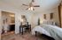 Elegant bedroom with cozy bed, stylish decor, a chic work desk, and an ensuite bathroom, creating a perfect blend of comfort and functionality.