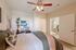 Cozy bedroom with modern ceiling fan, elegant decor, and bathroom access, perfect for relaxation and comfort.