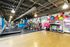 Vibrant apartment gym with modern exercise equipment, colorful mural, and polished wood flooring.