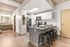 Modern apartment kitchen with sleek finishes, featuring a breakfast bar, stainless steel appliances, and stylish decor accents.