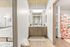 Chic modern bathroom with stylish vanity, trendy decor, and vibrant shower curtain, offering a glimpse into a cozy bedroom.
