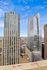 Breathtaking cityscape view featuring modern skyscrapers with stunning glass architecture under a vibrant blue sky.
