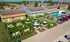 Inviting residential complex with lush green spaces, cozy hammocks, and shaded picnic areas, alongside a sparkling swimming pool offering a refreshing oasis.