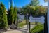 Inviting gated Bark Park exclusively for residents, surrounded by lush greenery and blue skies.