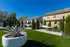 Inviting backyard with modern sculpture, dual hammocks, and lush greenery for a relaxing outdoor retreat.