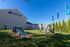 Inviting student housing with outdoor recreational area featuring agility equipment and lush greenery, ideal for vibrant student life.