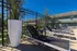 Inviting poolside area with sleek lounge chairs, vibrant greenery, and a serene outdoor setting, perfect for relaxation.