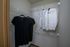 Spacious walk-in closet with organized shelving and neatly hung shirts, offering ample storage and convenience.