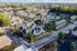 Charming aerial view of a vibrant apartment complex surrounded by lush greenery, showcasing community amenities and modern design.