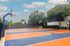 Vibrant outdoor basketball court with a modern design and lush greenery, perfect for active living in a community setting.