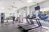 Bright and spacious fitness center featuring modern treadmills, free weights, and large mirrors, perfect for an invigorating workout.