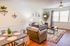 Inviting living room with cozy sofa, elegant decor, and bright natural light, perfect for relaxation and entertaining.