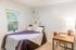 Bright and cozy bedroom with a comfy bed, stylish decor, and a functional workspace, perfect for relaxation and focus.
