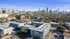 Modern apartment complex nestled in a vibrant urban landscape with stunning city skyline views and lush greenery.