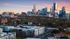 Captivating view of a vibrant cityscape with modern skyscrapers against a colorful sunset sky, showcasing an ideal urban living environment.