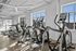Bright, modern fitness center with high-end Matrix exercise equipment and large windows for natural light.
