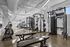 Modern apartment gym with state-of-the-art equipment, free weights, and cardio machines in a bright and spacious setting.