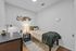 Cozy bedroom featuring stylish wall art, a sleek desk lamp, and warm lighting, perfect for a serene living experience.