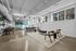 Contemporary office space with modern design elements, featuring open seating, natural light, and sleek furnishings.