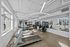Modern and bright fitness center featuring state-of-the-art equipment, large mirrors, and expansive windows for natural light.