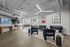 Modern office space with stylish seating, artistic wall decor, and elegant lighting fixtures.
