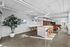Sleek open-concept kitchen and lounge area with modern decor, natural lighting, and stylish seating.